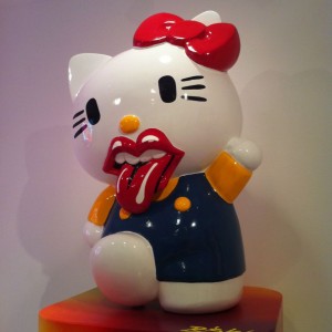 7. Hello Kitty's Moves (or Lips) Like Jagger: Ever wonder what Hello Kitty would look like with Mick Jagger's mouth? Wonder no more! In 2012 at Los Angeles's Known Gallery, two of pop culture's most enduring and most opposite icons — Japan's mouthless mascot, Hello Kitty, and England's mouthiest rock star, Mick Jagger — were forever fused in the most awesome, if slightly disconcerting, manner imaginable. Renowned graffiti artist RISK came up with the brilliantly subversive idea to superimpose the Rolling Stones' lips logo over the blank white space beneath Kitty's yellow button nose, and the effect was almost downright shocking. It brought a whole new meaning to the Stones' term "Beast 0f Burden," even. And yet... it was kind of amazing that no one had ever thought to do this before. Now, can we see what Mick Jagger would look like wearing Hello Kitty's red bow? Come on, RISK, make it happen!